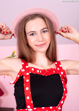 Marvelous long-haired teen beauty poses in red stockings and a hat, and gets totally naked